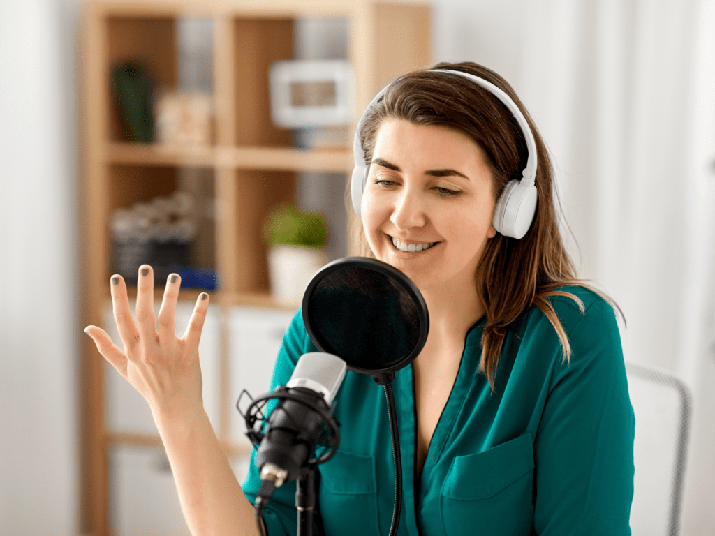 A woman listening to headphones and talking on mic